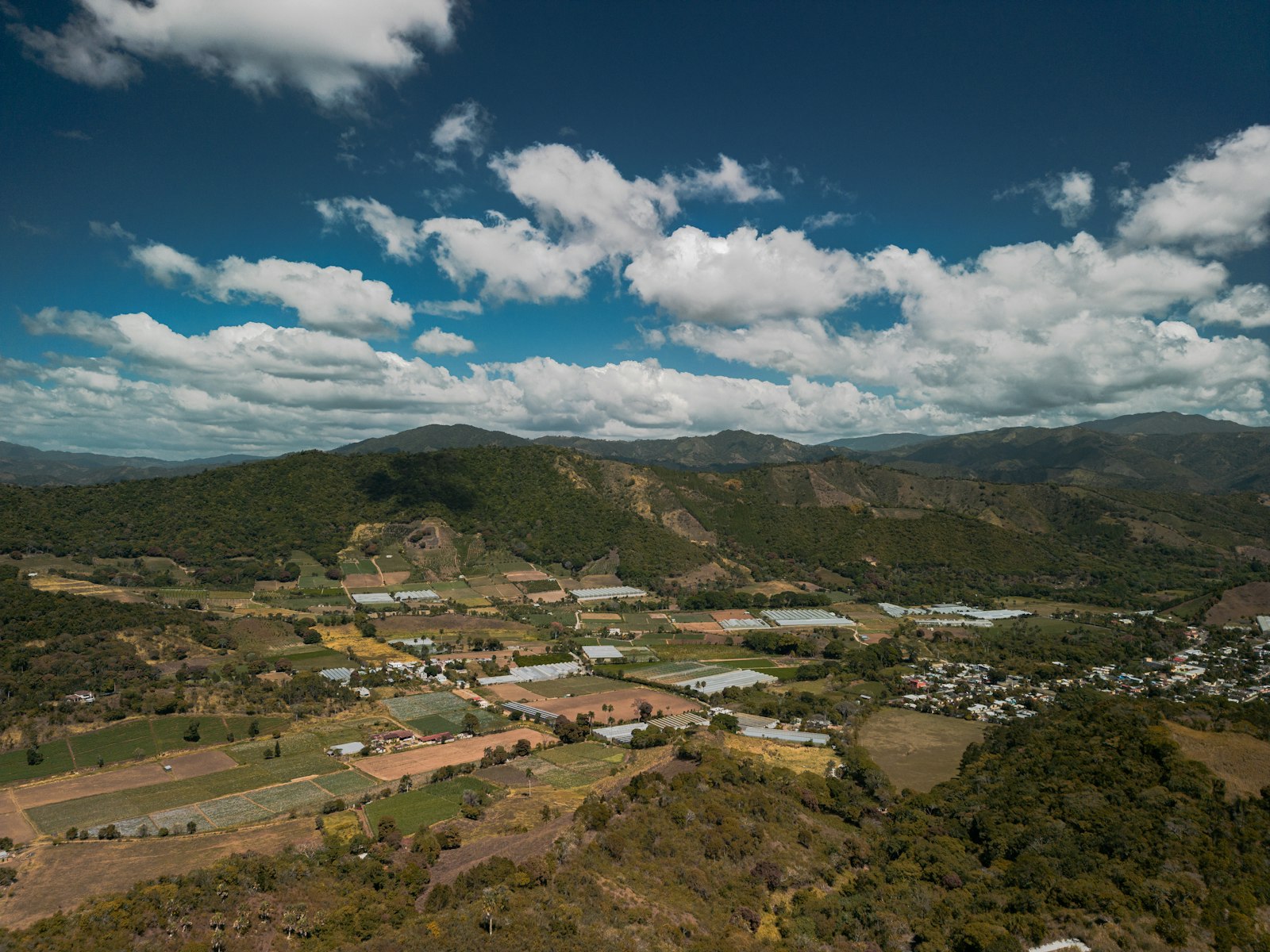 Aerial view of a small town nestled in mountain valleys