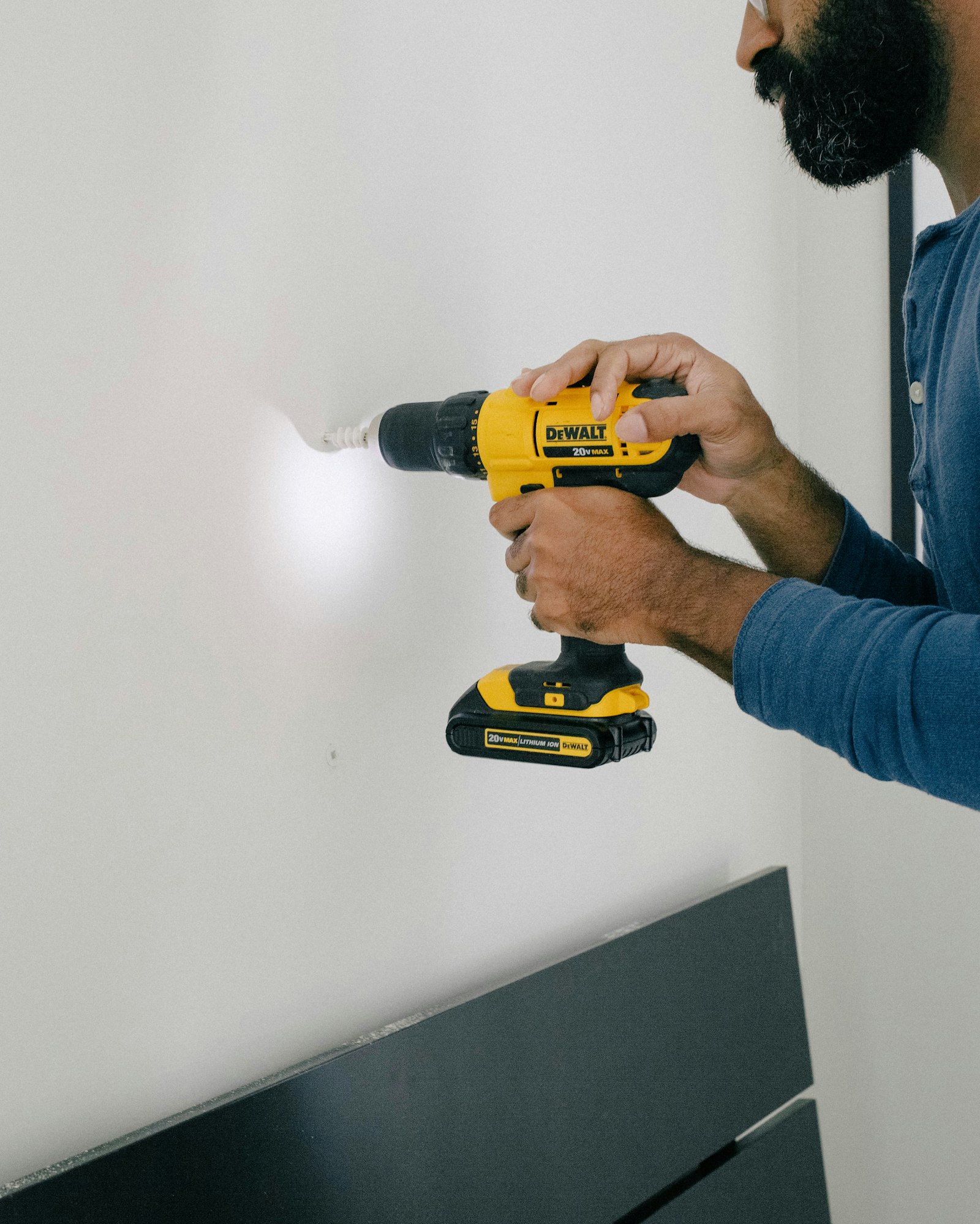 Hand holding a cordless drill for home repairs