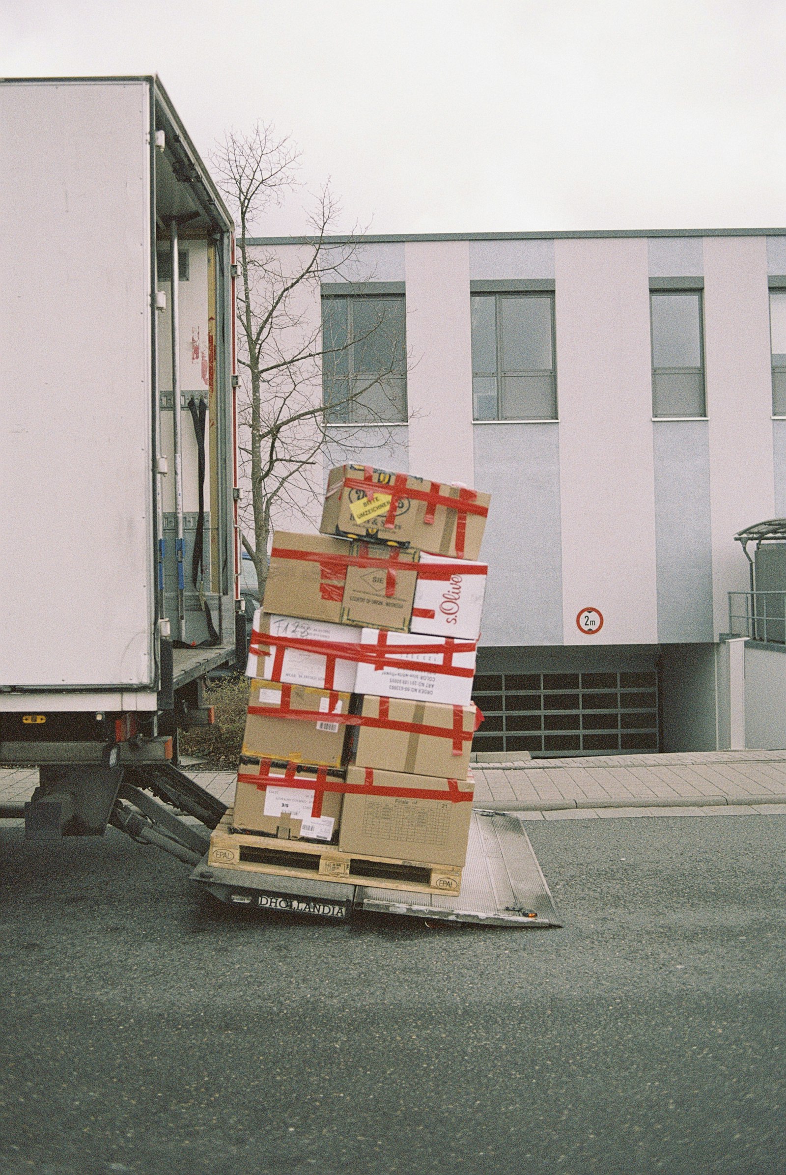 Stacked moving boxes on a street, ready for relocation